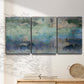 Three-panel canvas wall art featuring cool dreamy abstraction, displayed in a minimalist living room above a console table.