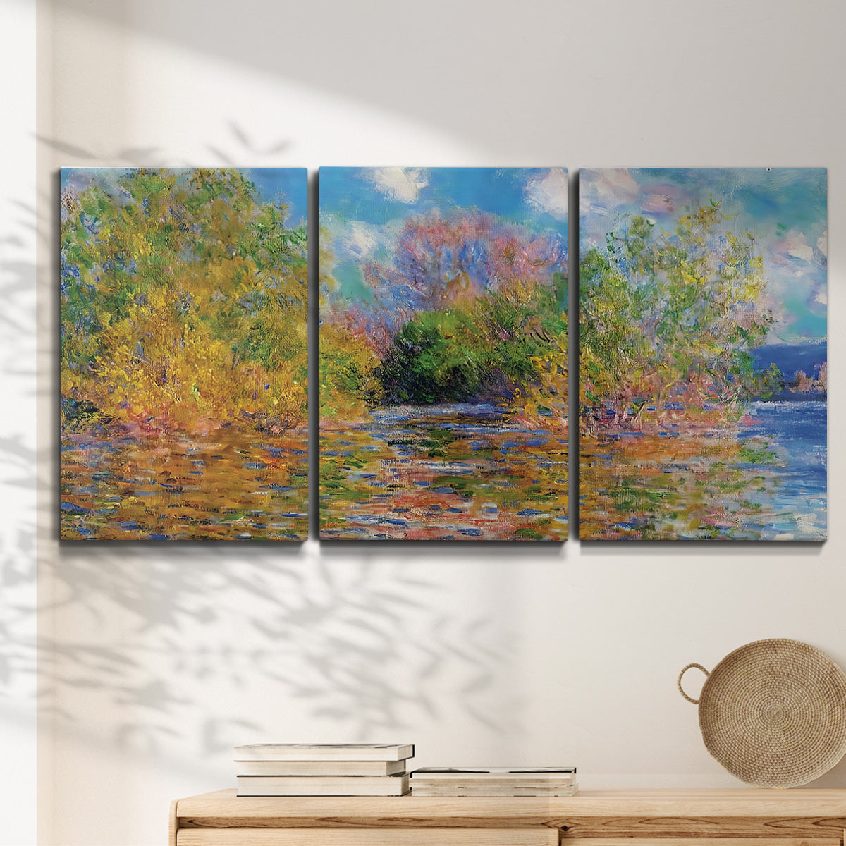 Three-panel canvas wall art featuring wide river landscape, displayed in a minimalist living room above a console table.