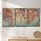 Three-panel canvas wall art featuring autumn foliage landscape photograph, displayed in a minimalist living room above a console table.
