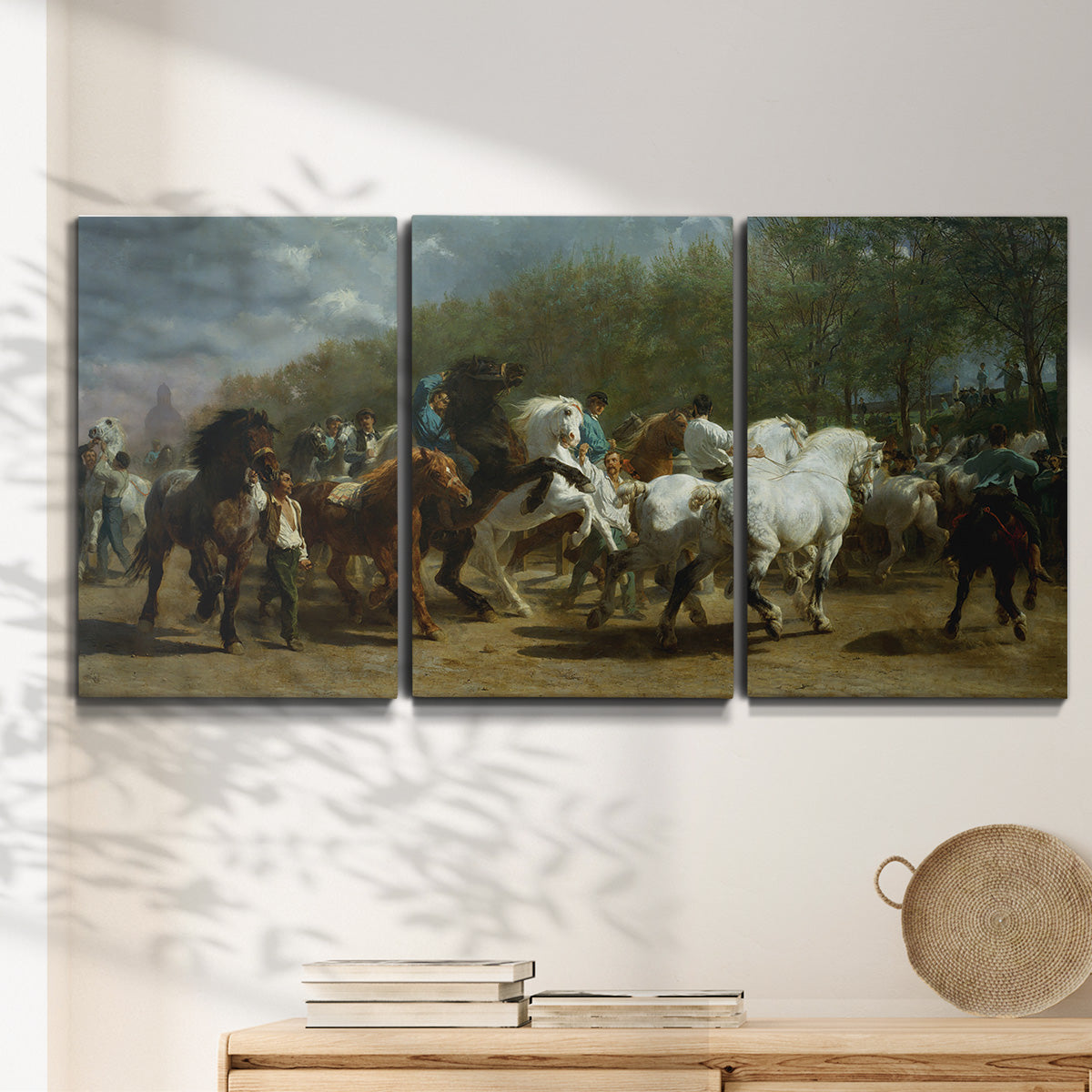 Three-panel canvas wall art featuring crowded horse fair scene, displayed in a minimalist living room above a console table.
