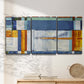 Three-panel canvas wall art featuring bright mid century geometric abstraction, displayed in a minimalist living room above a console table.