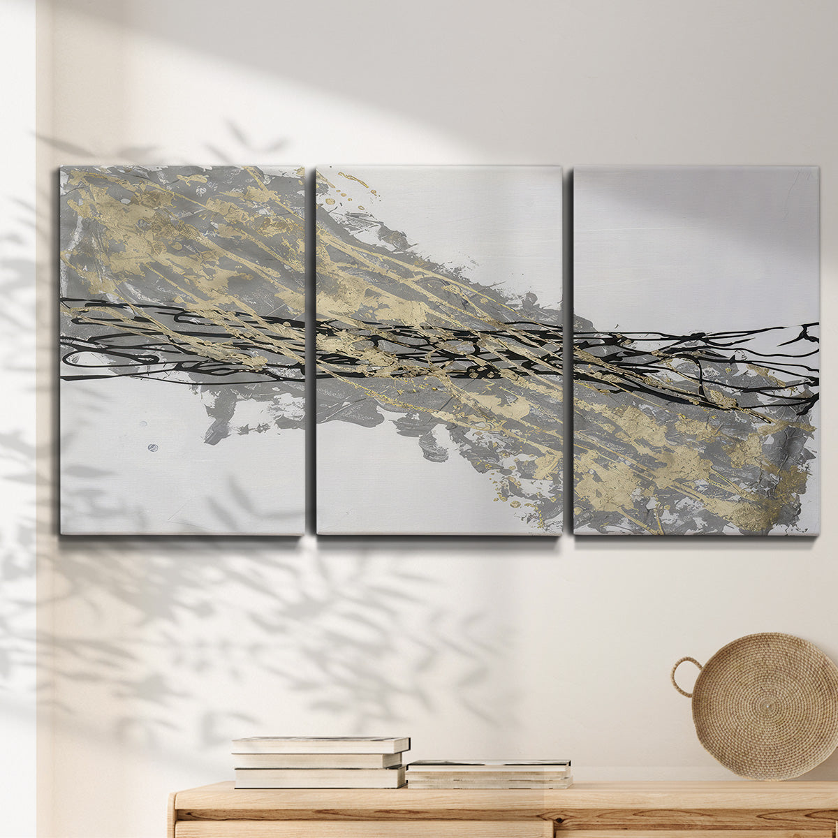 Three-panel canvas wall art featuring light modern abstract wind patterns, displayed in a minimalist living room above a console table.