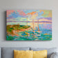 Colorful seascape with boats and vibrant skies over a coastal landscape in late afternoon light