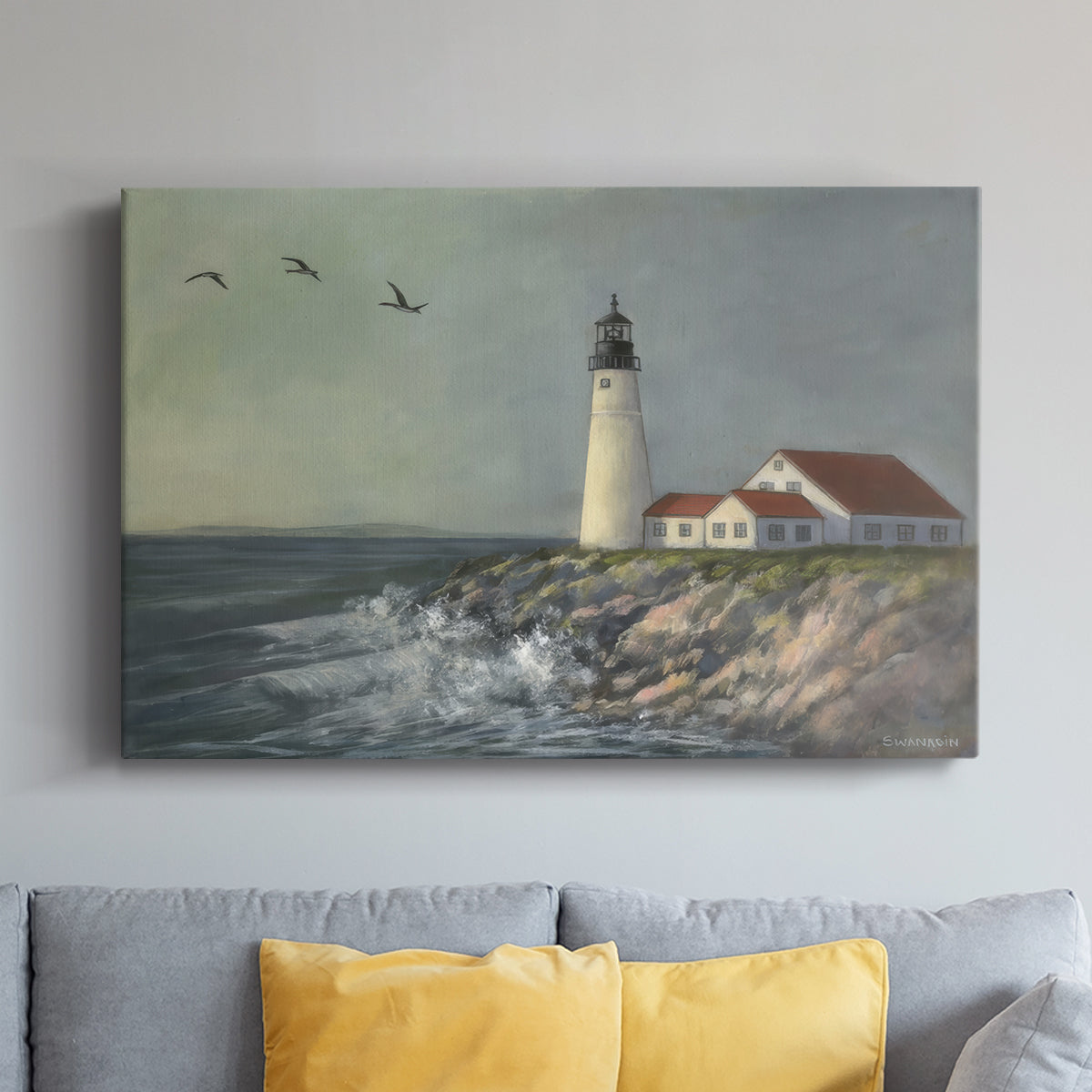 Lighthouse stands tall against crashing waves at a coastal location with birds flying overhead during a calm day