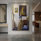 Canvas art print of a Baroque interior of a woman standing at a virginal in soft light displayed as a statement piece in a spacious interior.