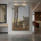 Canvas art print of a realistic scene of figures near the pyramids in a sunlit desert landscape displayed as a statement piece in a spacious interior.