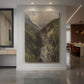 Canvas art print of a dramatic mountain gorge with a cascading waterfall and rugged rock formations displayed as a statement piece in a spacious interior.