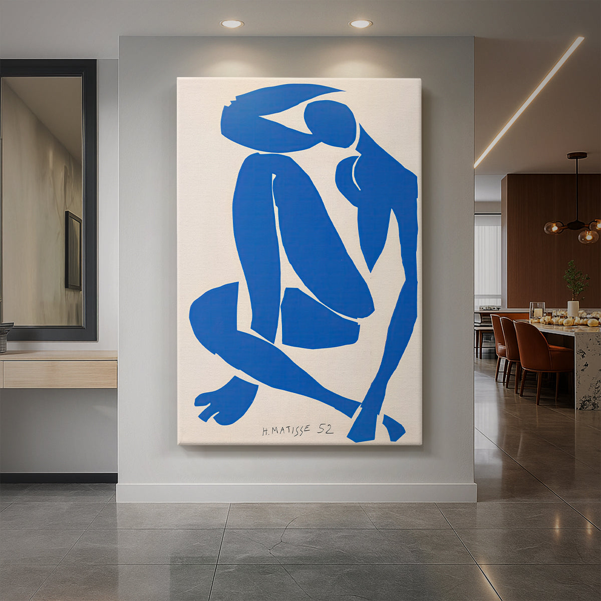 Canvas art print of an abstract cut-out figure of a reclining nude in bold blue shapes displayed as a statement piece in a spacious interior.
