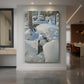 Canvas art print of a snowy winter forest with animal tracks leading through deep untouched snow displayed as a statement piece in a spacious interior.