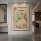 Canvas art print of an Art Nouveau poster of a woman with ornate details and corset advertisement text displayed as a statement piece in a spacious interior.