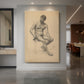 Canvas art print of a figure study of a seated male nude turned to the left with soft shading displayed as a statement piece in a spacious interior.