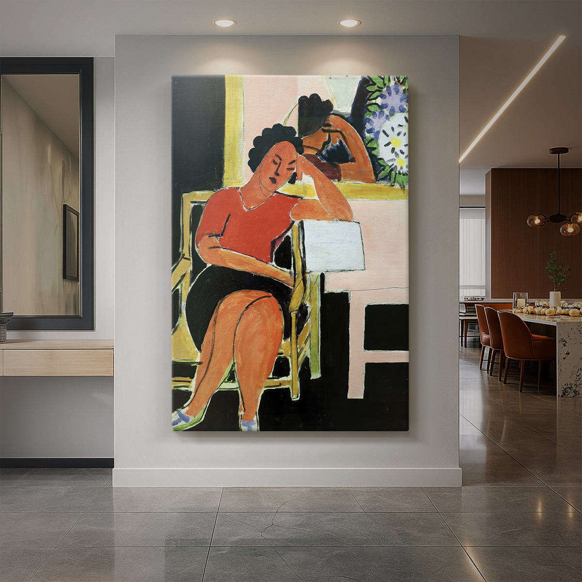 Canvas art print of a modern portrait of a woman reading against a dark background with bold color displayed as a statement piece in a spacious interior.