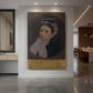 Canvas art print of a realistic portrait of a woman wearing a purple shawl with soft tones displayed as a statement piece in a spacious interior.