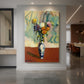 Canvas art print of a fauvist still life of chrysanthemums in a decorative vase with bright color displayed as a statement piece in a spacious interior.