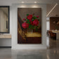 Canvas art print of a still life of red roses arranged against a dark background with soft light displayed as a statement piece in a spacious interior.