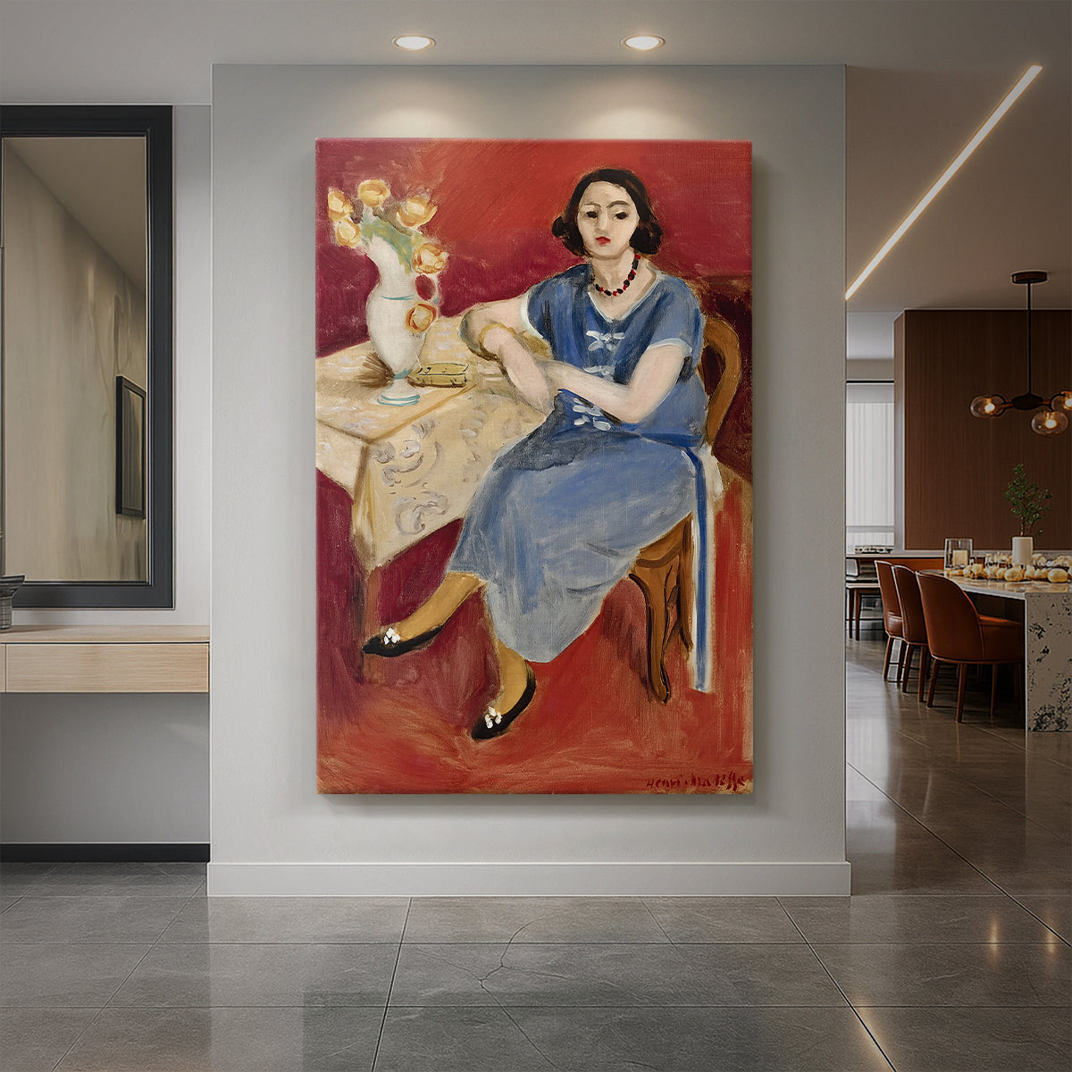 Canvas art print of a fauvist portrait of a seated woman in blue against a bold red background displayed as a statement piece in a spacious interior.