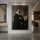 Canvas art print of a Baroque portrait of a seated man in dark clothing with soft light displayed as a statement piece in a spacious interior.