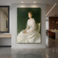 Canvas art print of an impressionist portrait of a seated woman in white with soft light displayed as a statement piece in a spacious interior.