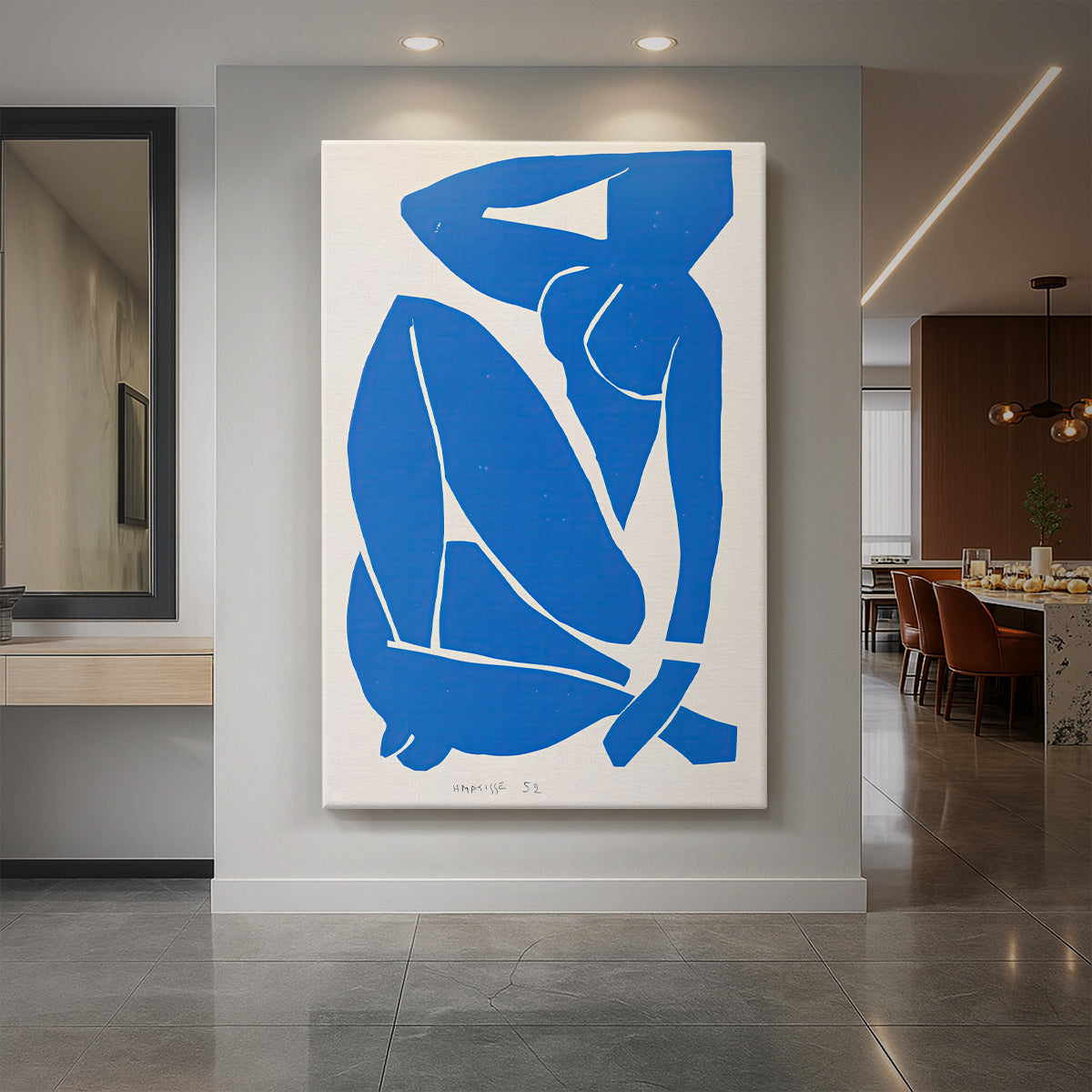 Canvas art print of an abstract cut-out figure of a seated nude in bold blue shapes displayed as a statement piece in a spacious interior.