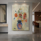 Canvas art print of a symbolic still life of flowers in a large vase with soft color transitions displayed as a statement piece in a spacious interior.
