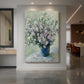Canvas art print of an impressionist still life of flowers in a vase with soft blended colors displayed as a statement piece in a spacious interior.