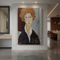 Canvas art print of an expressionist portrait of a woman with elongated features and soft muted tones displayed as a statement piece in a spacious interior.