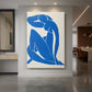 Canvas art print of an abstract figure of a seated nude in deep blue with cut-out forms displayed as a statement piece in a spacious interior.