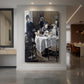 Canvas art print of an impressionist interior scene of figures gathered around a dining table displayed as a statement piece in a spacious interior.