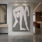 Canvas art print of an abstract figure of an acrobat formed with simplified geometric shapes displayed as a statement piece in a spacious interior.