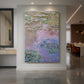 Canvas art print of an impressionist water scene with floating lilies and reflective surface displayed as a statement piece in a spacious interior.