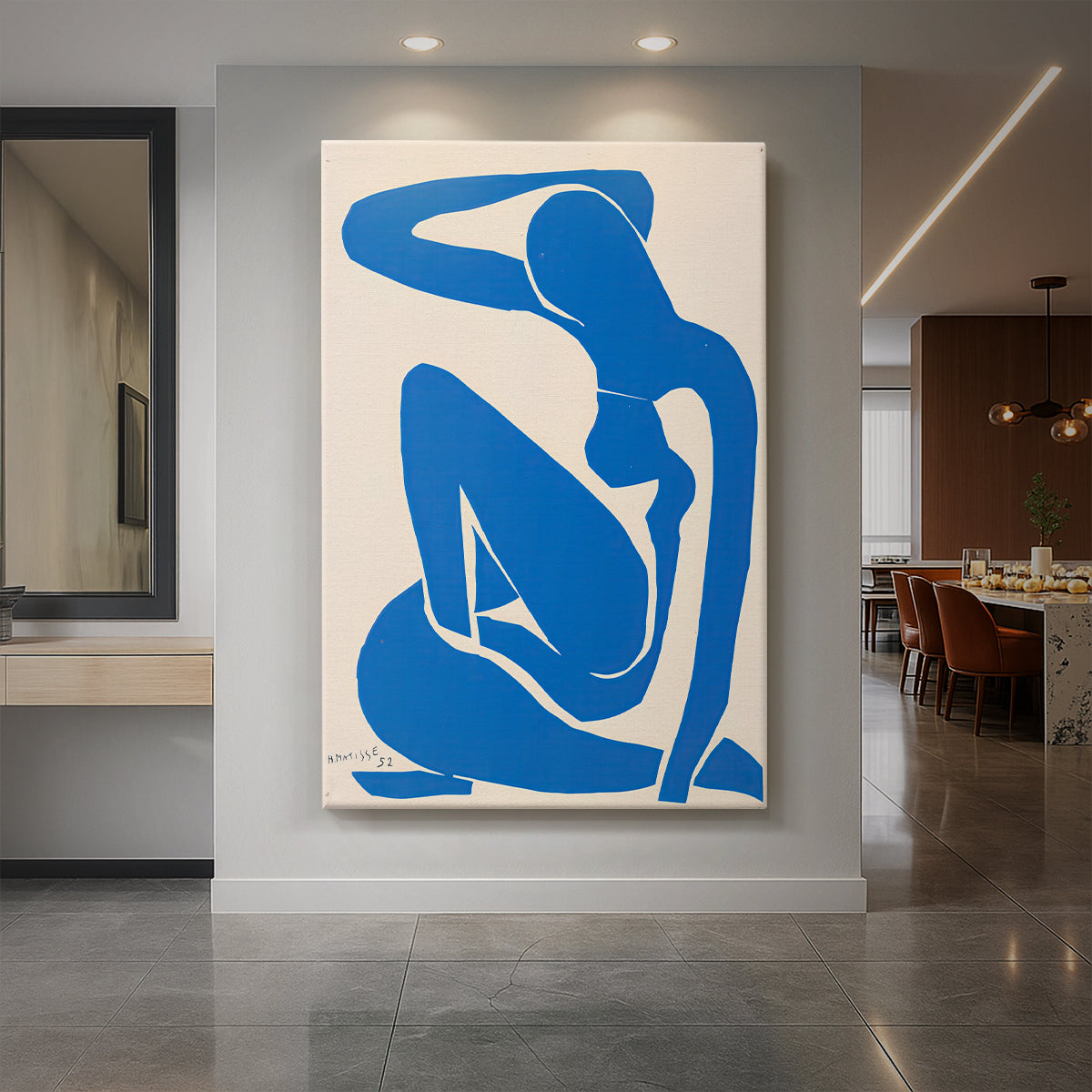 Canvas art print of an abstract figure of a reclining nude in bold blue cut-out shapes displayed as a statement piece in a spacious interior.