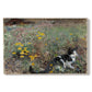 Canvas art print portraying a cat crouching in a meadow filled with wildflowers and greenery, set against a white background