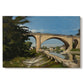 Canvas art print portraying an arched bridge spanning river with structure reflected in water, set against a white background