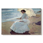 Canvas art print portraying a woman seated on beach in flowing white dress beside water, set against a white background
