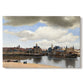 Canvas art print portraying a cityscape of Delft with buildings reflected in calm water, set against a white background