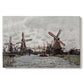 Canvas art print portraying windmills standing beside water under open sky in rural landscape, set against a white background