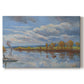 Canvas art print portraying a riverside landscape with water trees and distant structures, set against a white background