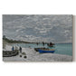 Canvas art print portraying a seaside promenade with figures, flags, and boats along the coast, set against a white background
