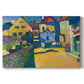 Canvas art print portraying a village street with colorful houses and trees lining a narrow road, set against a white background