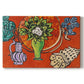 Canvas art print portraying magnolia flowers arranged in a vase within a patterned still life, set against a white background
