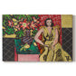 Canvas art print portraying a seated woman beside a vase of amaryllis in a richly patterned interior, set against a white background