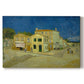 Canvas art print portraying a street view with bright yellow house and neighboring buildings under blue sky, set against a white background