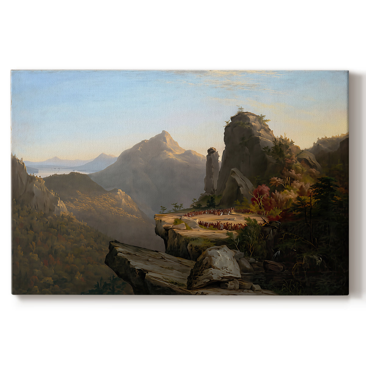 Canvas art print portraying a rugged mountain landscape with small figures near water and rocky cliffs, set against a white background
