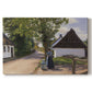 Canvas art print portraying a woman and milkman standing along village street with houses nearby, set against a white background