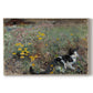 Canvas art print portraying a cat crouching in a meadow filled with wildflowers and greenery, set against a white background