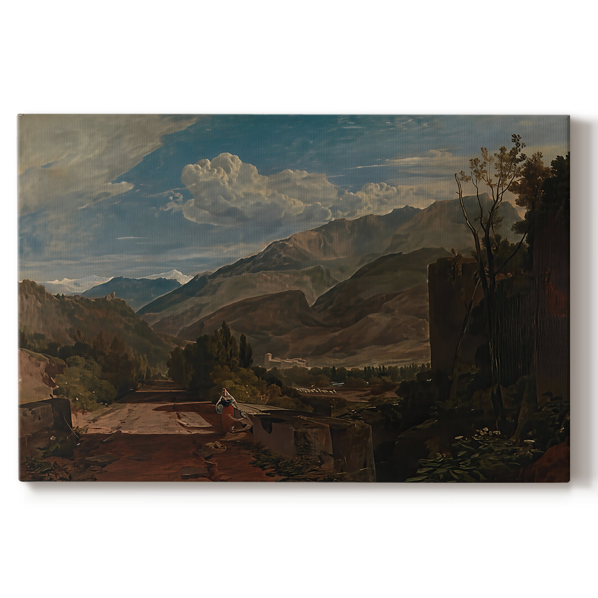 Canvas art print portraying a mountain landscape with town and river under dramatic sky, set against a white background