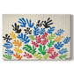 Canvas art print portraying an abstract arrangement of colorful leaf-like cut-outs, set against a white background