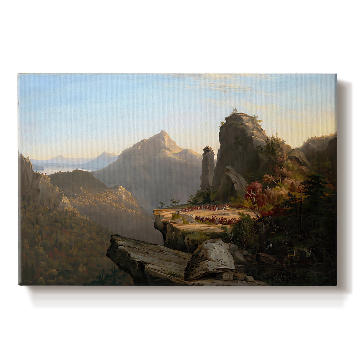 Canvas art print portraying a rugged mountain landscape with small figures near water and rocky cliffs, set against a white background