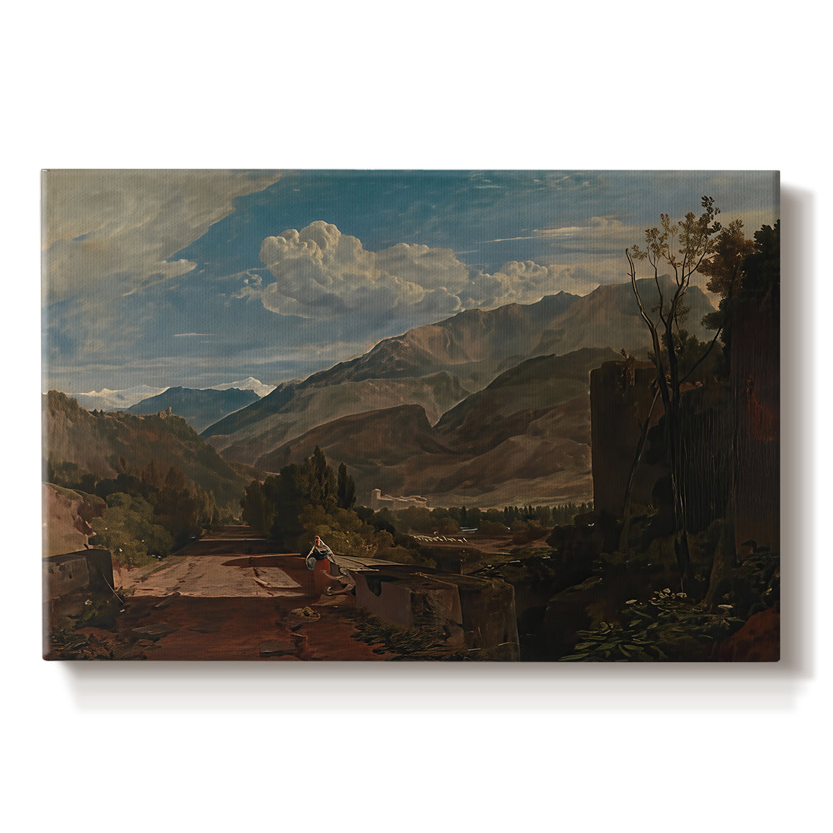 Canvas art print portraying a mountain landscape with town and river under dramatic sky, set against a white background