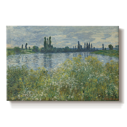 Canvas art print portraying a riverbank landscape with water, trees, and distant village buildings, set against a white background